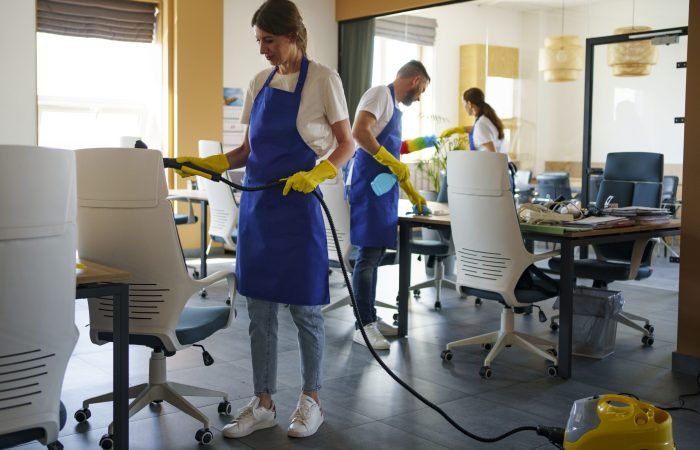 professional-cleaning-service-person-using-vacuum-cleaner-office